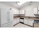 Modern kitchen, granite countertops, white appliances, and cabinets at 2204 Kendall Hill Ave, Las Vegas, NV 89106