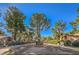 The Village Green community entrance with lush landscaping and gated access at 2360 Pickwick Dr, Henderson, NV 89014