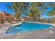 Community pool with surrounding lounge chairs at 2360 Pickwick Dr, Henderson, NV 89014