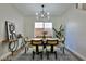 Bright dining room featuring a wood dining table and modern light fixture at 2892 Rothesay Ave, Henderson, NV 89044