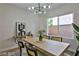 Modern dining area showcasing a sleek dining table and stylish light fixture at 2892 Rothesay Ave, Henderson, NV 89044