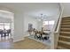 Elegant dining room with a modern light fixture and a wood dining table at 2892 Rothesay Ave, Henderson, NV 89044