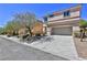 Two-story house exterior with driveway and landscaping at 2892 Rothesay Ave, Henderson, NV 89044