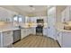 Bright kitchen featuring white shaker cabinets, stainless steel appliances, and light wood flooring at 2892 Rothesay Ave, Henderson, NV 89044