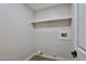 Bright laundry room with washer/dryer hookups and built-in shelving at 2892 Rothesay Ave, Henderson, NV 89044