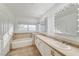 Bathroom with double vanity, soaking tub, and lighted mirrors at 3655 Funston Way, Las Vegas, NV 89129