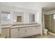 Double vanity bathroom with lighted mirrors and shower at 3655 Funston Way, Las Vegas, NV 89129