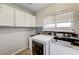 Laundry room with washer, dryer, and cabinets at 3655 Funston Way, Las Vegas, NV 89129