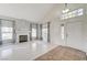 Bright living room with hardwood floors, fireplace, and large windows at 3655 Funston Way, Las Vegas, NV 89129