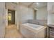 Elegant bathroom featuring a soaking tub and tiled walls at 3726 Las Vegas Blvd # 2310, Las Vegas, NV 89158