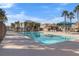 Community swimming pool with lounge chairs and umbrellas at 375 Kensington Palace Ave # 3, North Las Vegas, NV 89032