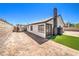 Home exterior view showcasing the dirt backyard, bordered by block fencing and a black trimmed door at 3875 Sebasco Dr, Las Vegas, NV 89147