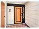 Inviting entryway with an orange door and terracotta tile flooring at 3875 Sebasco Dr, Las Vegas, NV 89147