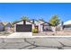 Charming single-story house with a landscaped front yard and a two-car garage at 3875 Sebasco Dr, Las Vegas, NV 89147