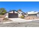 Single-story home with a dark-grey garage door and nicely landscaped yard at 3875 Sebasco Dr, Las Vegas, NV 89147