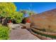 Beautiful backyard with a fire pit, tiered planters, and a well-designed brick retaining wall at 4450 Palisades Canyon Cir, Las Vegas, NV 89129