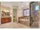 Bathroom with granite finishes, soaking tub, and walk-in shower at 4450 Palisades Canyon Cir, Las Vegas, NV 89129