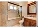 Bright bathroom features a granite shower and tub, plus granite countertop and wood cabinet at 4450 Palisades Canyon Cir, Las Vegas, NV 89129