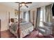 Luxurious bedroom with a four-poster bed, hardwood floors, and balcony access at 4450 Palisades Canyon Cir, Las Vegas, NV 89129