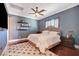 Bedroom with blue walls, hardwood floors, and a ceiling fan at 4450 Palisades Canyon Cir, Las Vegas, NV 89129