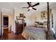 Spacious bedroom featuring a four-poster bed, dark wood floors and decorative art at 4450 Palisades Canyon Cir, Las Vegas, NV 89129