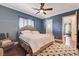 Bedroom with blue walls, hardwood floors, and a large window with shutters at 4450 Palisades Canyon Cir, Las Vegas, NV 89129