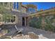 Inviting courtyard with stone accents, cozy seating, and lush greenery offers an intimate outdoor retreat at 4450 Palisades Canyon Cir, Las Vegas, NV 89129