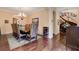 Elegant dining room with hardwood floors, chandelier, and views of stairs at 4450 Palisades Canyon Cir, Las Vegas, NV 89129