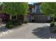 Paver driveway leading to a three-car garage, flanked by lush landscaping at 4450 Palisades Canyon Cir, Las Vegas, NV 89129