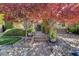 Inviting entryway with a stone path, lush landscaping, and a charming gate at 4450 Palisades Canyon Cir, Las Vegas, NV 89129