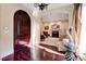 Entryway with a dark wood door, hardwood floors, and an arched opening to the living room at 4450 Palisades Canyon Cir, Las Vegas, NV 89129