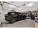 A modern garage featuring a sleek black SUV and built-in storage solutions at 4450 Palisades Canyon Cir, Las Vegas, NV 89129