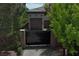 Three-car garage accessible through a black iron security gate on a private street at 4450 Palisades Canyon Cir, Las Vegas, NV 89129