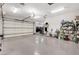 A spacious garage with epoxy floors, an open garage door, and plenty of room for storage at 4450 Palisades Canyon Cir, Las Vegas, NV 89129