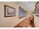 Hallway featuring hardwood floors, shuttered windows, and framed artwork creating a gallery-like atmosphere at 4450 Palisades Canyon Cir, Las Vegas, NV 89129