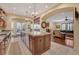 Open-concept kitchen features wood cabinets, granite counters, stainless appliances, and access to the living room at 4450 Palisades Canyon Cir, Las Vegas, NV 89129