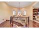 The second-floor landing overlooks the bottom floor with a chandelier and hardwood floors at 4450 Palisades Canyon Cir, Las Vegas, NV 89129