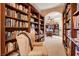 Charming library with built-in wooden bookshelves, cozy seating, and warm lighting at 4450 Palisades Canyon Cir, Las Vegas, NV 89129