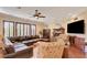 Spacious living room features a cozy fireplace, hardwood floors, and a comfortable leather sectional sofa at 4450 Palisades Canyon Cir, Las Vegas, NV 89129