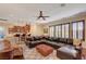 Spacious living room with dark leather furniture, hardwood floors, and a ceiling fan at 4450 Palisades Canyon Cir, Las Vegas, NV 89129