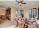 Sunlit home office featuring a wooden desk, built-in bookshelves, and natural light at 4450 Palisades Canyon Cir, Las Vegas, NV 89129