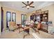 Bright and spacious office with a ceiling fan, multiple windows, and traditional wood furniture at 4450 Palisades Canyon Cir, Las Vegas, NV 89129