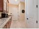 Bright pantry with granite countertops, wood cabinets and white doors at 4450 Palisades Canyon Cir, Las Vegas, NV 89129