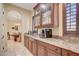 Charming pantry boasts granite countertops, wood cabinets and views of breakfast nook at 4450 Palisades Canyon Cir, Las Vegas, NV 89129