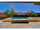 Beautiful rectangular pool with manicured landscaping and brick patio deck at 4450 Palisades Canyon Cir, Las Vegas, NV 89129
