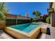 Backyard pool and hot tub with brick patio and landscaping at 4450 Palisades Canyon Cir, Las Vegas, NV 89129