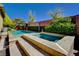 Backyard pool and hot tub with concrete patio and landscaping at 4450 Palisades Canyon Cir, Las Vegas, NV 89129
