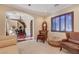 Bright sitting room featuring hardwood floors, comfortable seating, and a grand staircase at 4450 Palisades Canyon Cir, Las Vegas, NV 89129