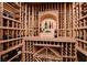 Well-organized wine cellar with wooden racks and display alcove provides ample storage for wine bottles at 4450 Palisades Canyon Cir, Las Vegas, NV 89129