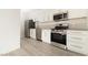 Modern kitchen with stainless steel appliances and white cabinets at 4480 Sandy River Dr # 64, Las Vegas, NV 89103